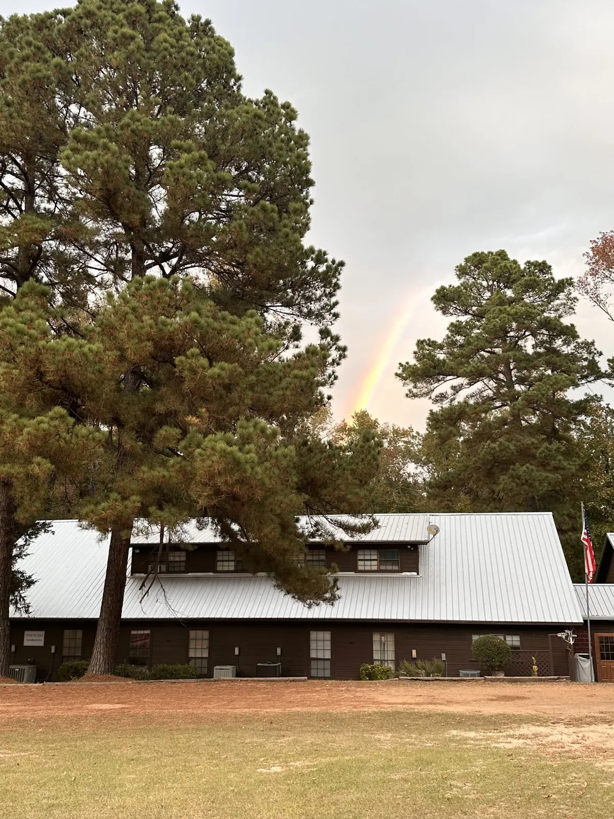The lodge at Shepherd’s Pasture surrounded by tall East Texas pines